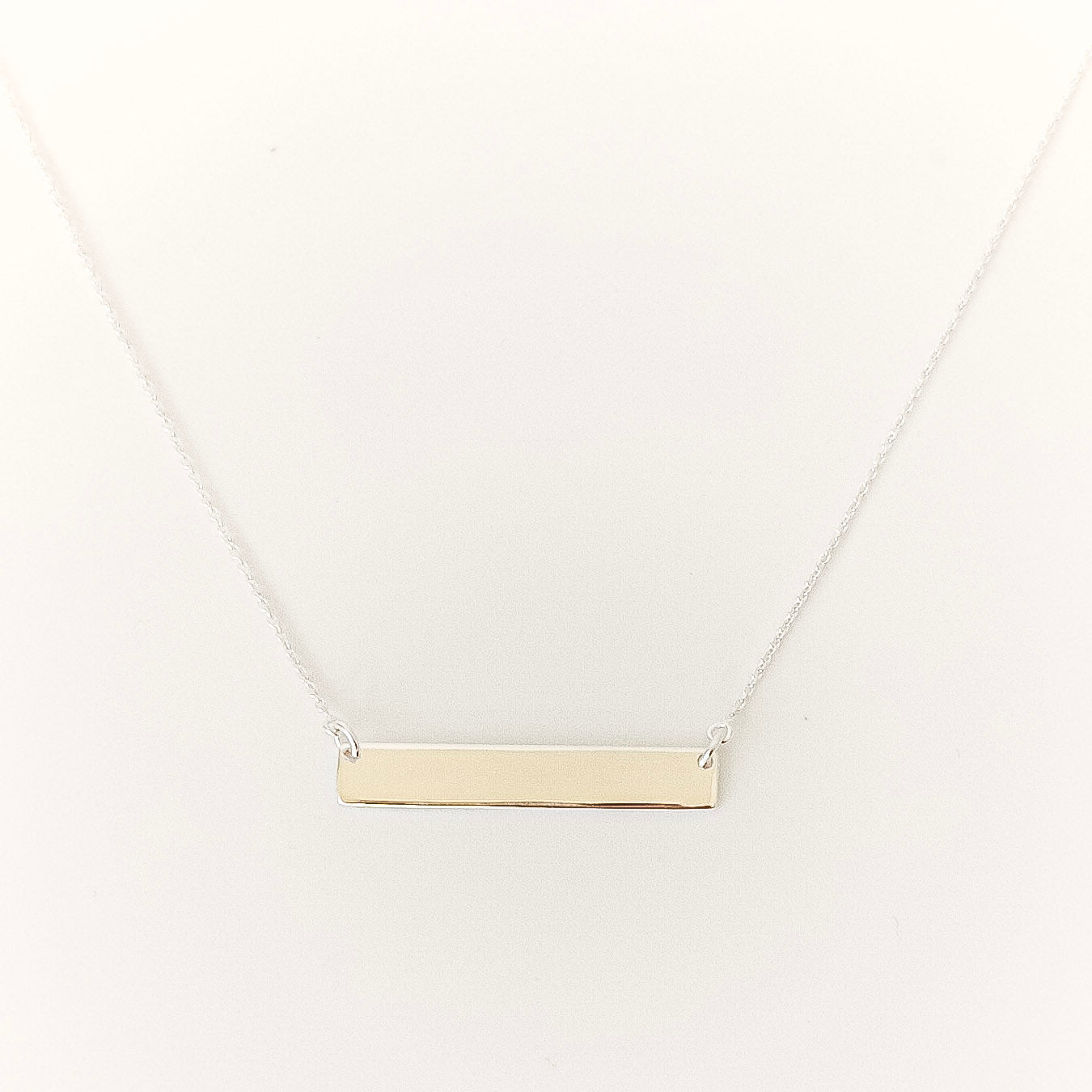 silver bar necklace on a white background