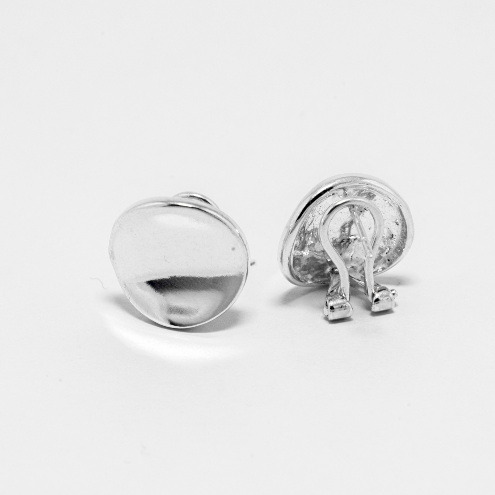 Pair of silver earrings on a light gray background