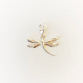 Silver dragonfly pendant on a light beige background