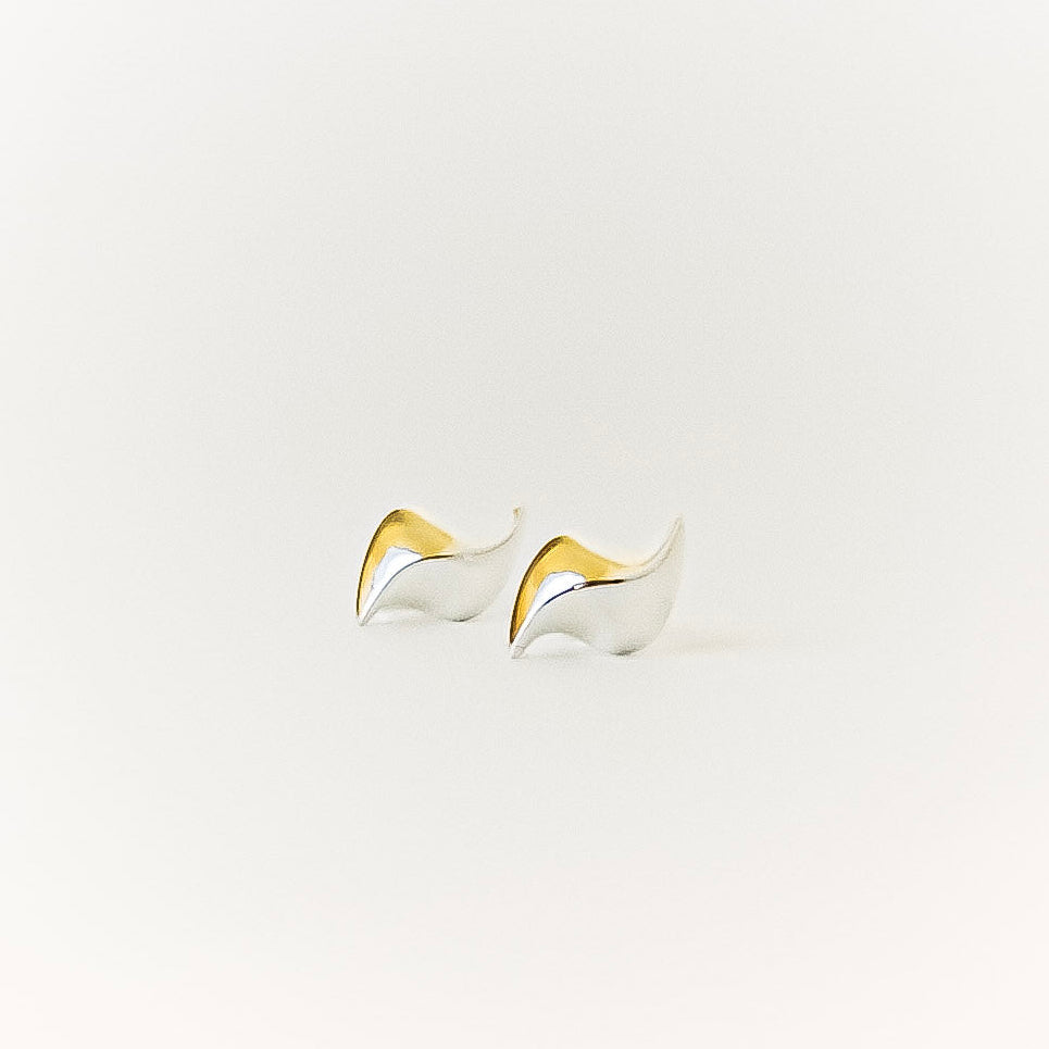 Pair of silver wave earrings on a white background