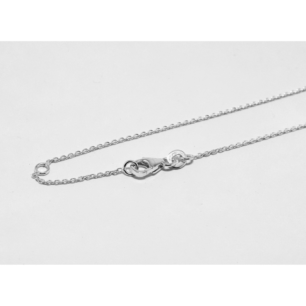 Silver chain necklace on a light gray background