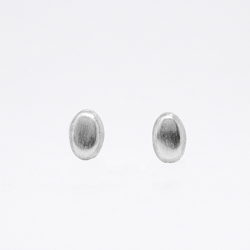 Pair of silver oval stud earrings on a white background