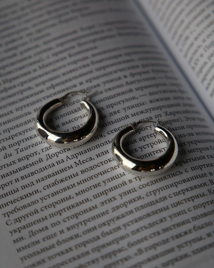 Silver hoops on book page