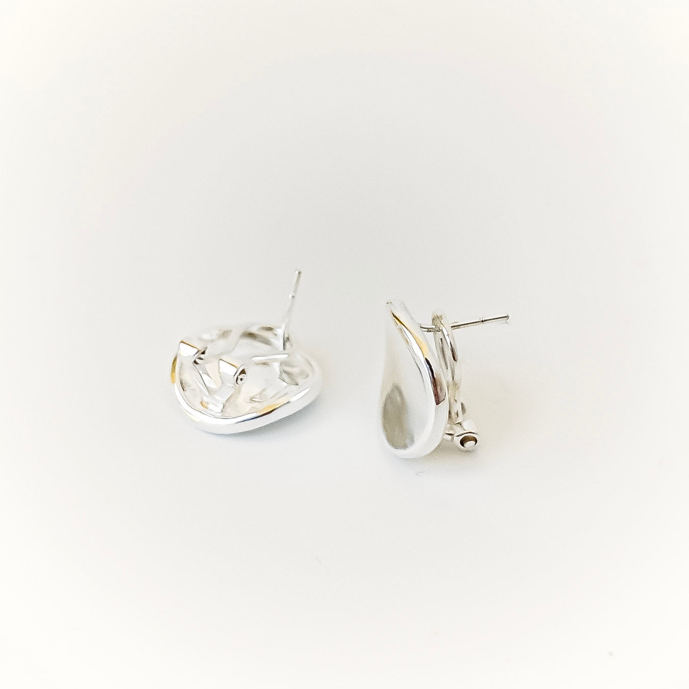 Pair of silver hoop earrings on a white background