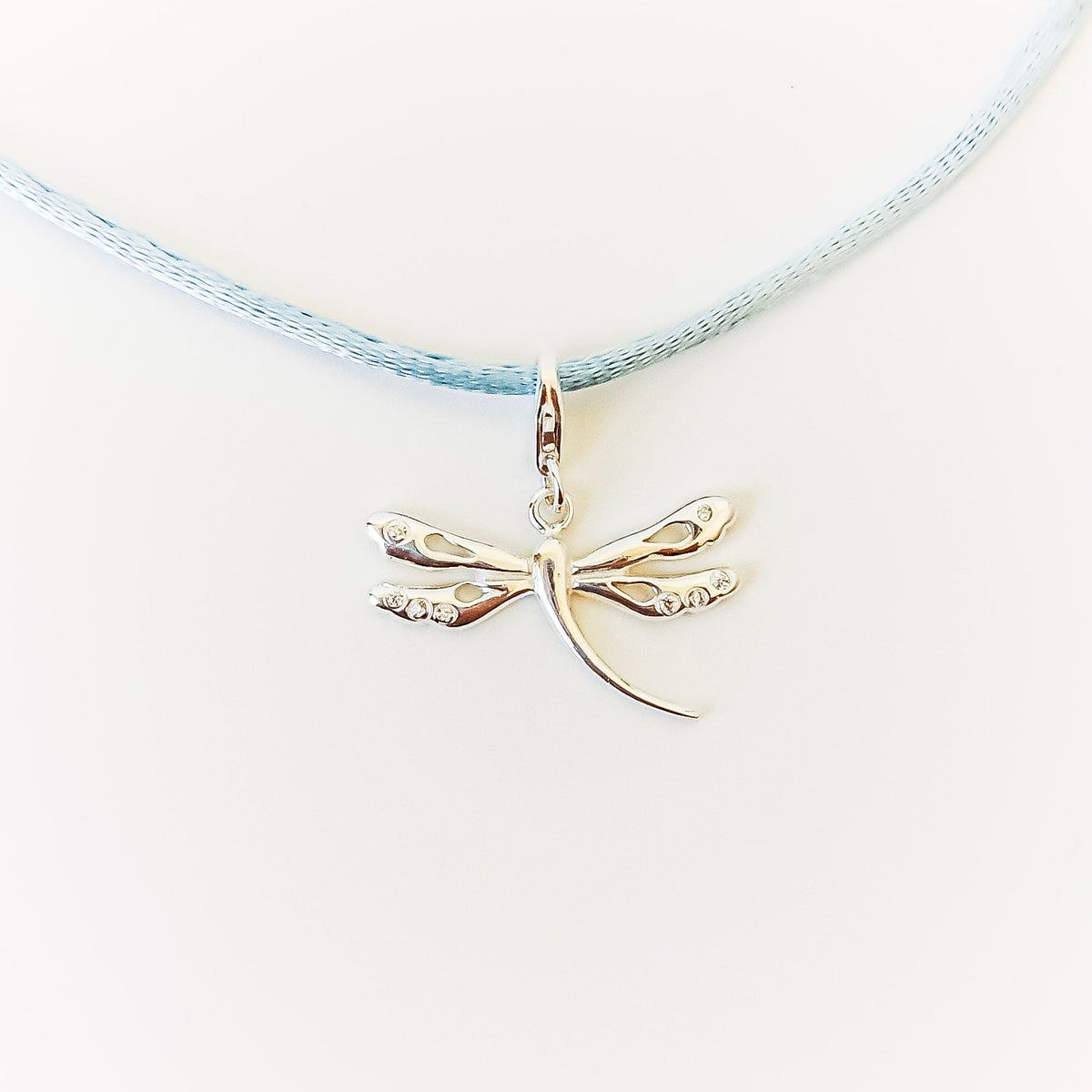OJA Silver dragonfly charm on light blue cord