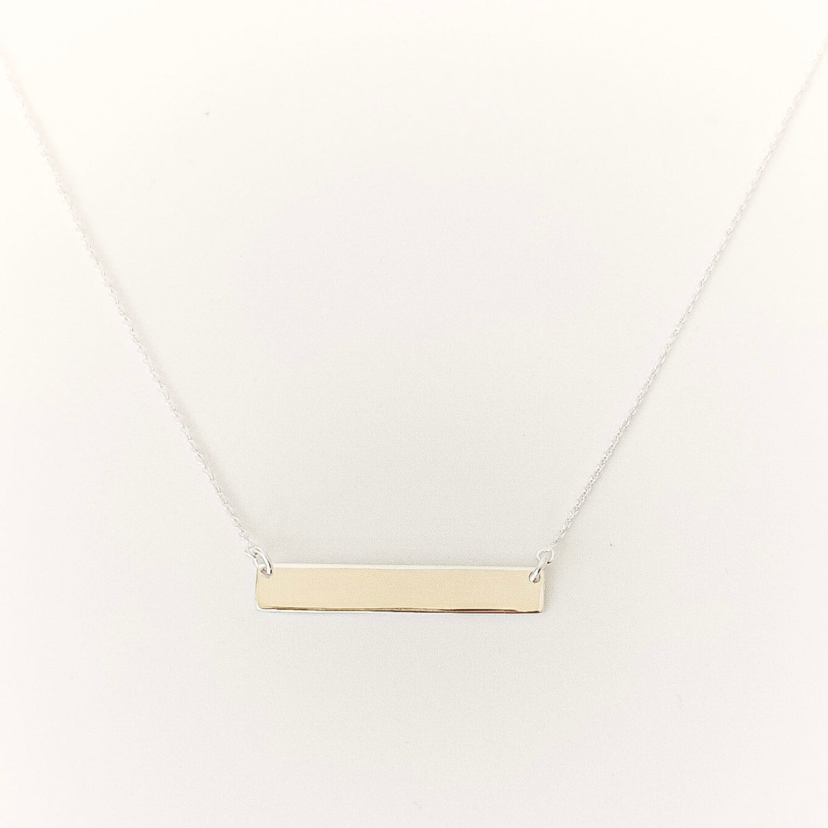 silver bar necklace on a white background