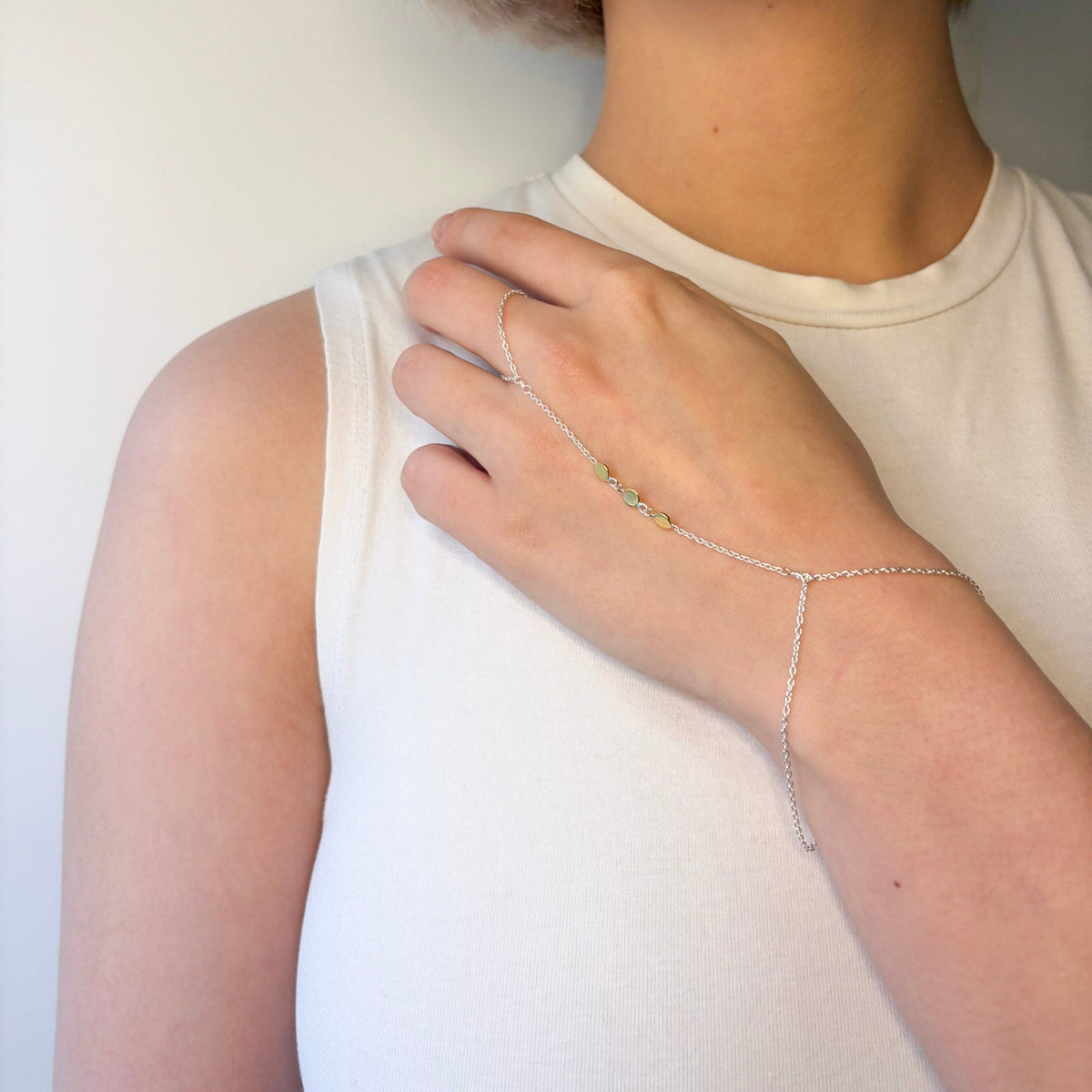 Person wearing OJA Silver continuum silver bracelet on a plain background