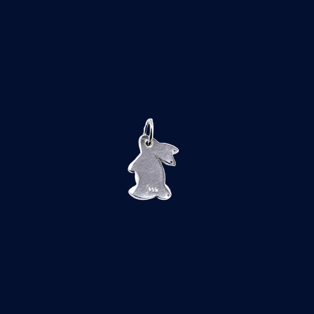 Silver bunny charm on a dark blue background