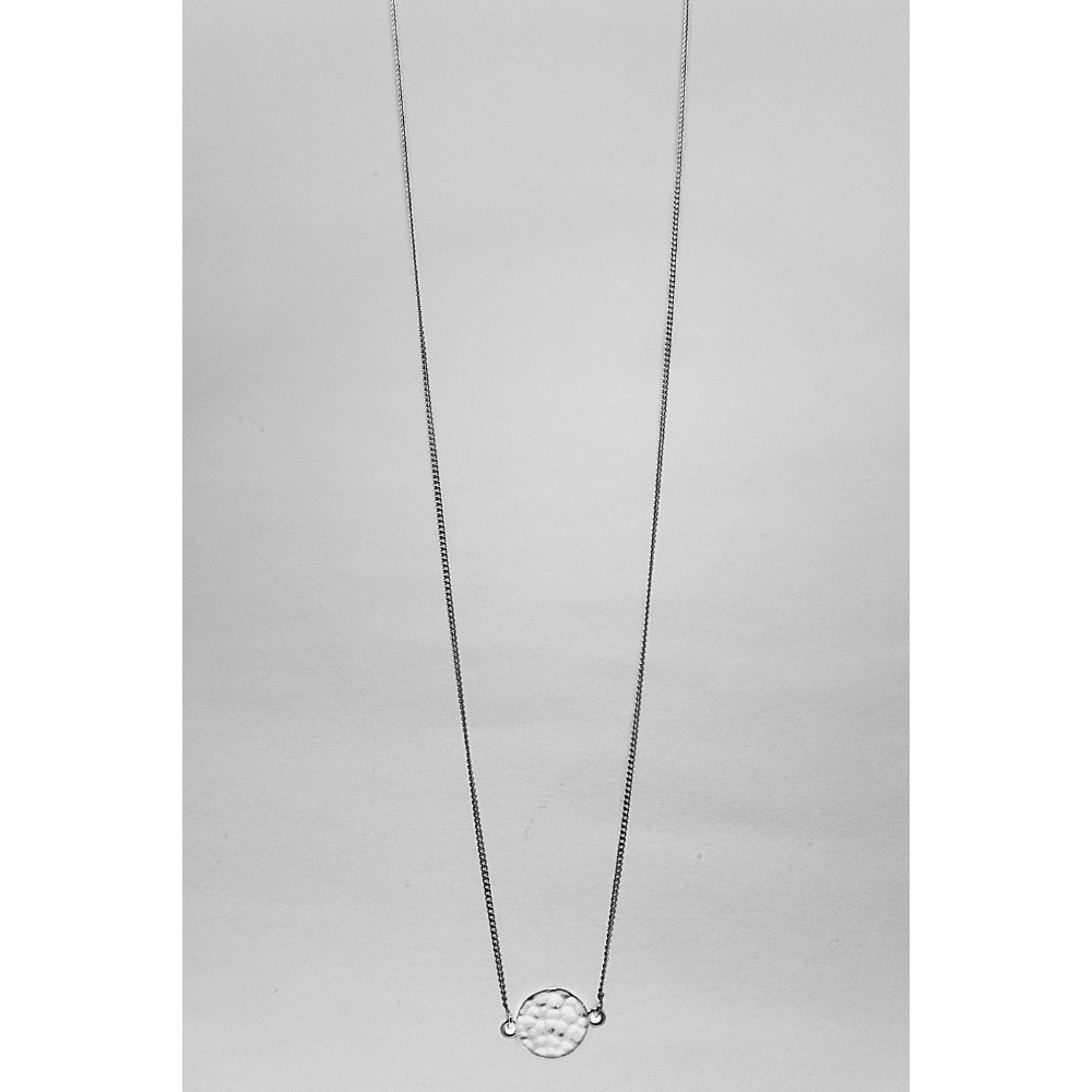 Silver necklace with a small pendant on a light grey background