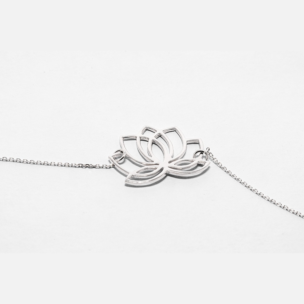 Silver lotus flower necklace on a white background