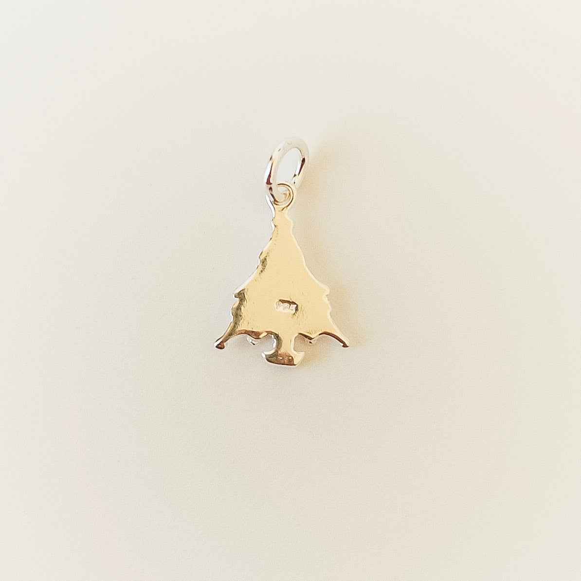tree-shaped pendant on a light beige background