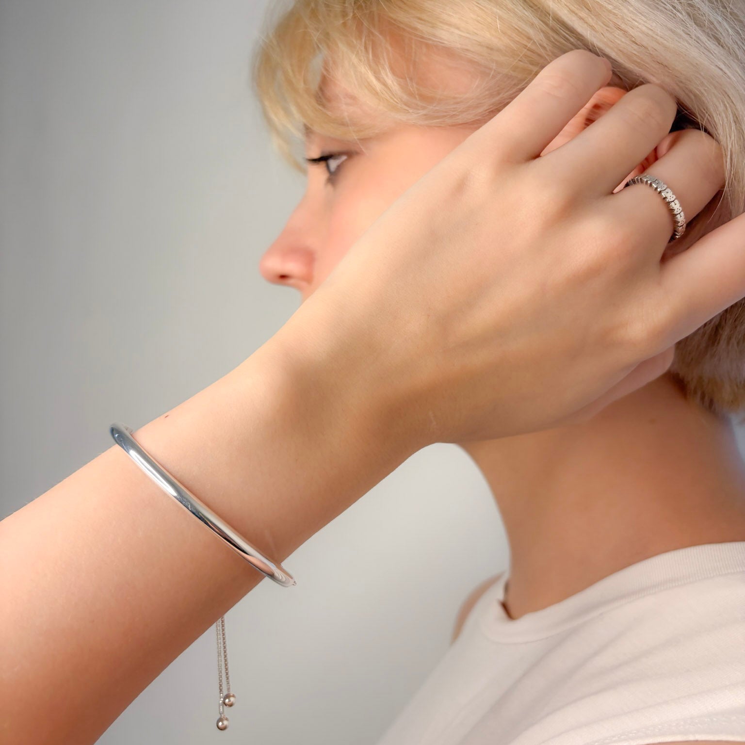 Person wearing a silver bracelet 