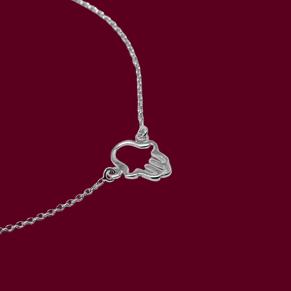 Silver bracelet with a unique pendant on a red background