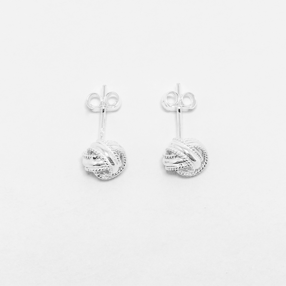 Pair of silver earrings on a light gray background