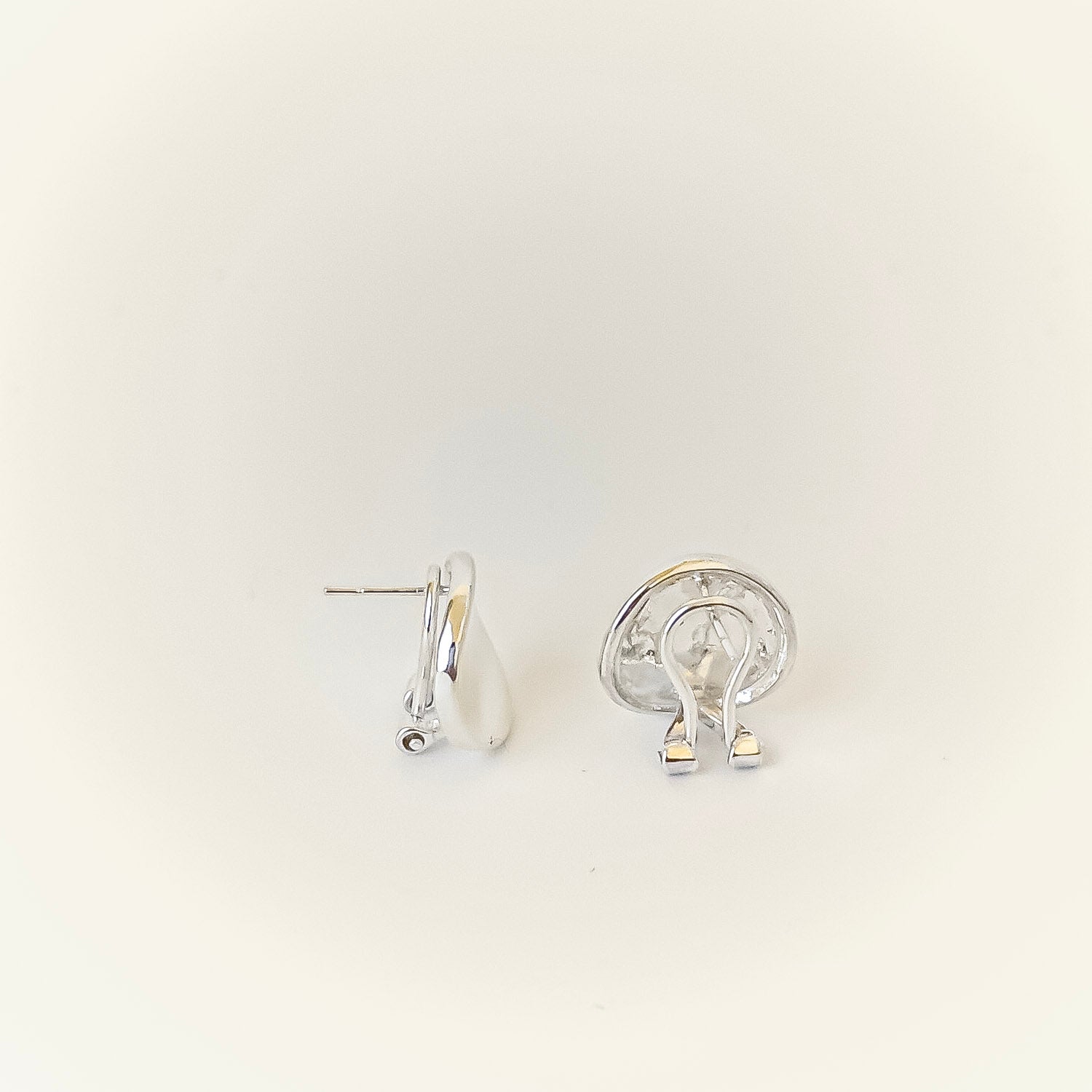 Pair of silver hoop earrings on a light gray background