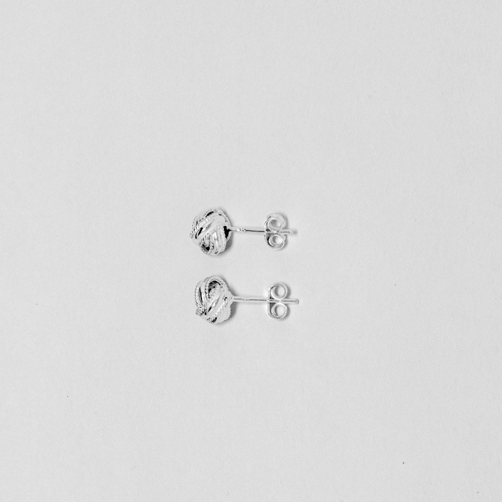 Pair of silver earrings on a light gray background