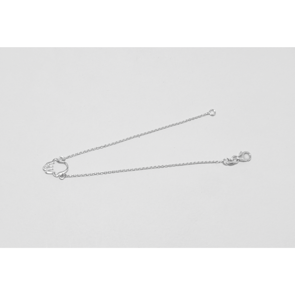 Silver chain necklace on a light gray background