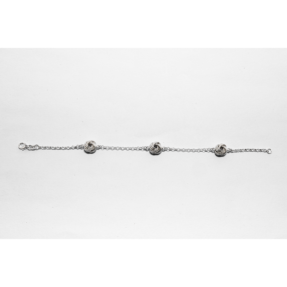 Silver bracelet with three interlocking knot charms on a white background