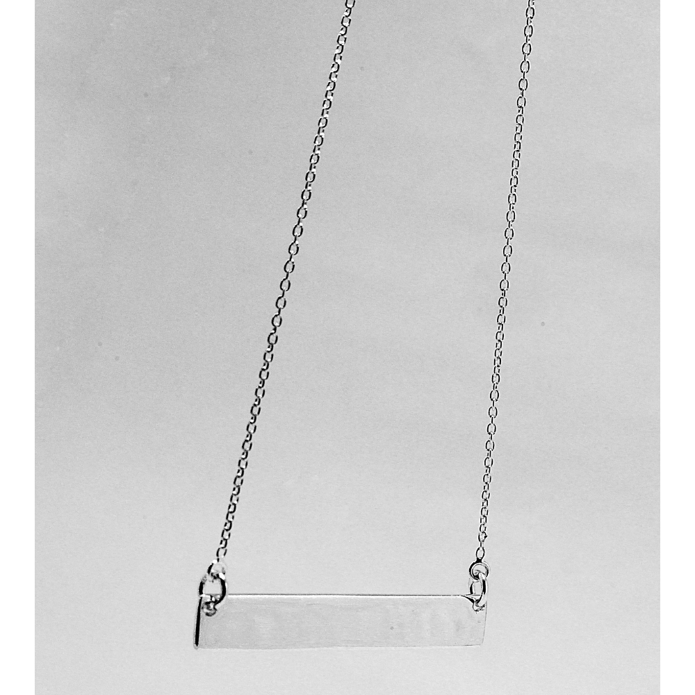 Silver necklace on a light gray background