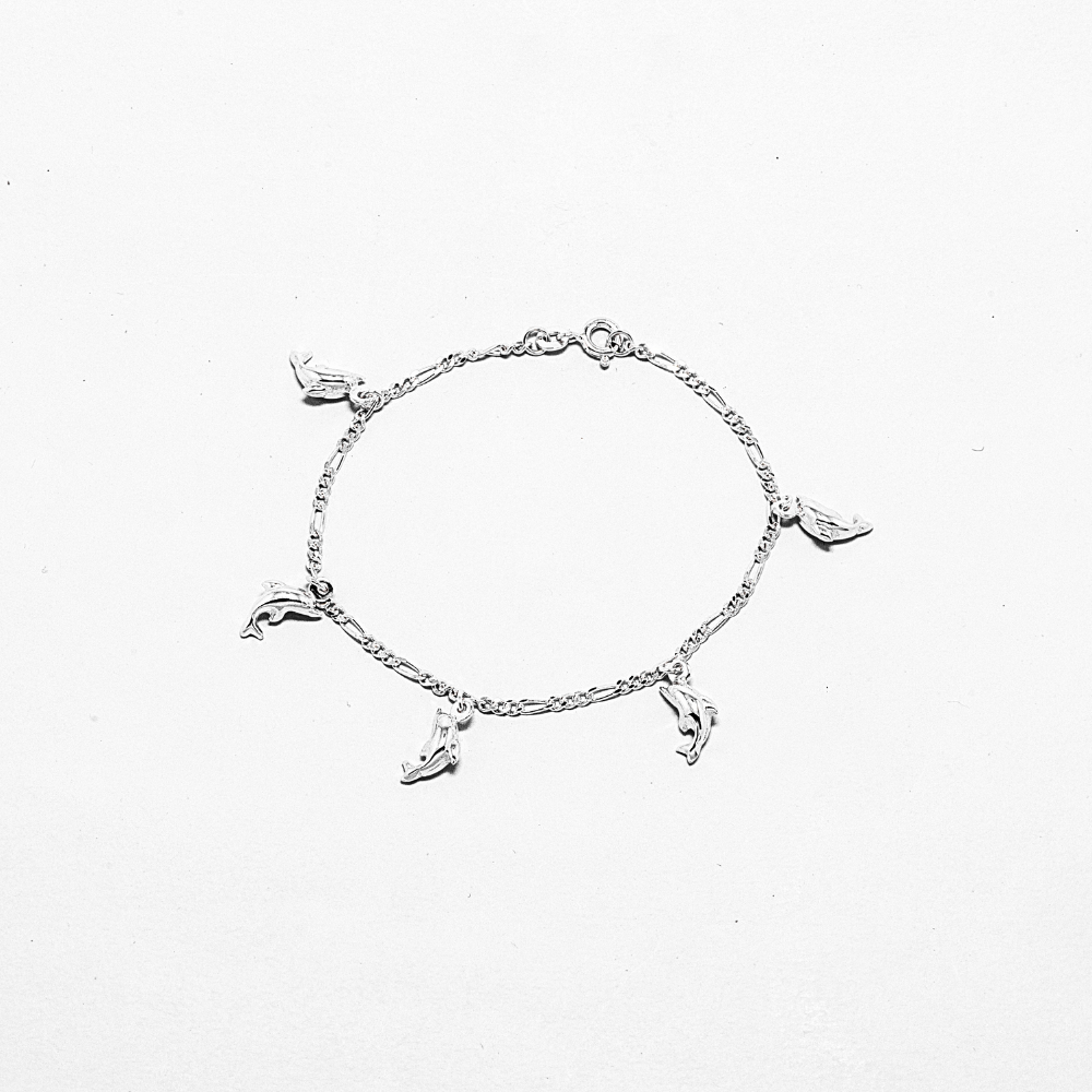 Silver anklet with small dolphin charms on a white background