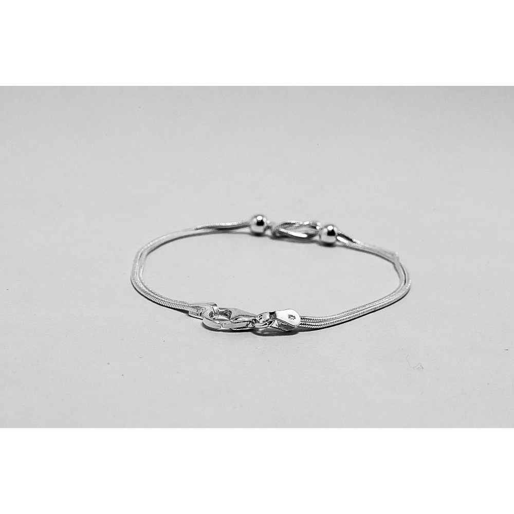 Silver bead bracelet on a light grey background