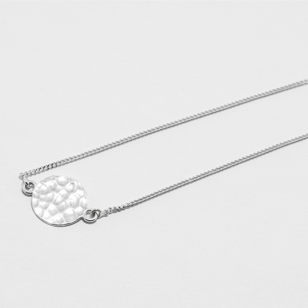 Silver necklace with a textured pendant 