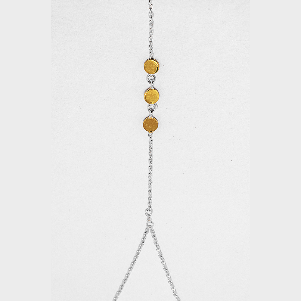 Necklace with gold beads and silver chain on a light grey background