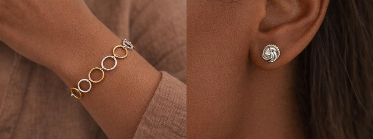 Close-up of a bracelet and earrings on a person wearing a brown outfit.